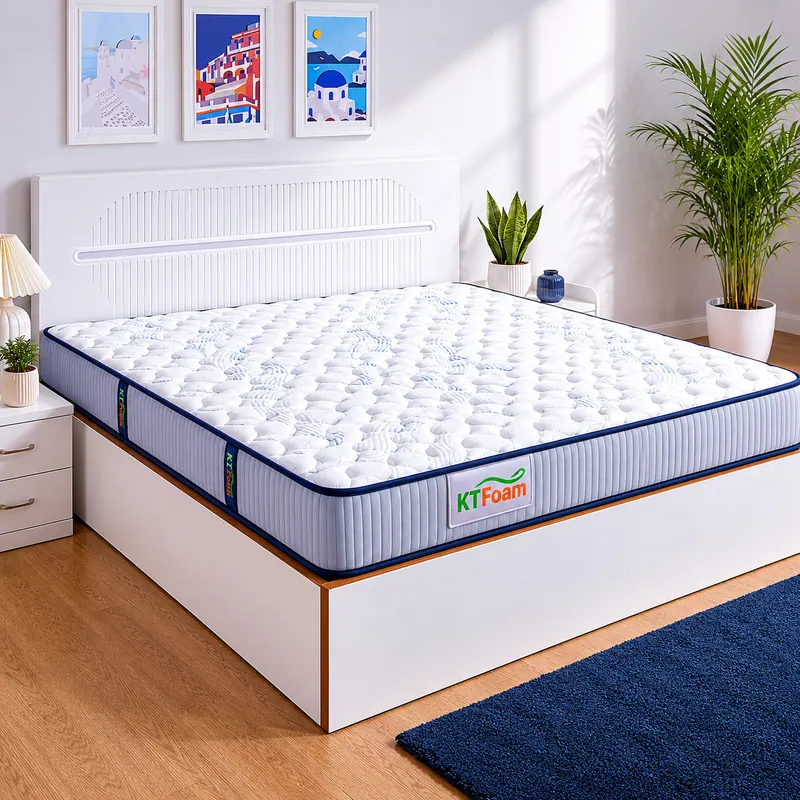 White quilted Bonnell spring mattress with blue banding on a bed base