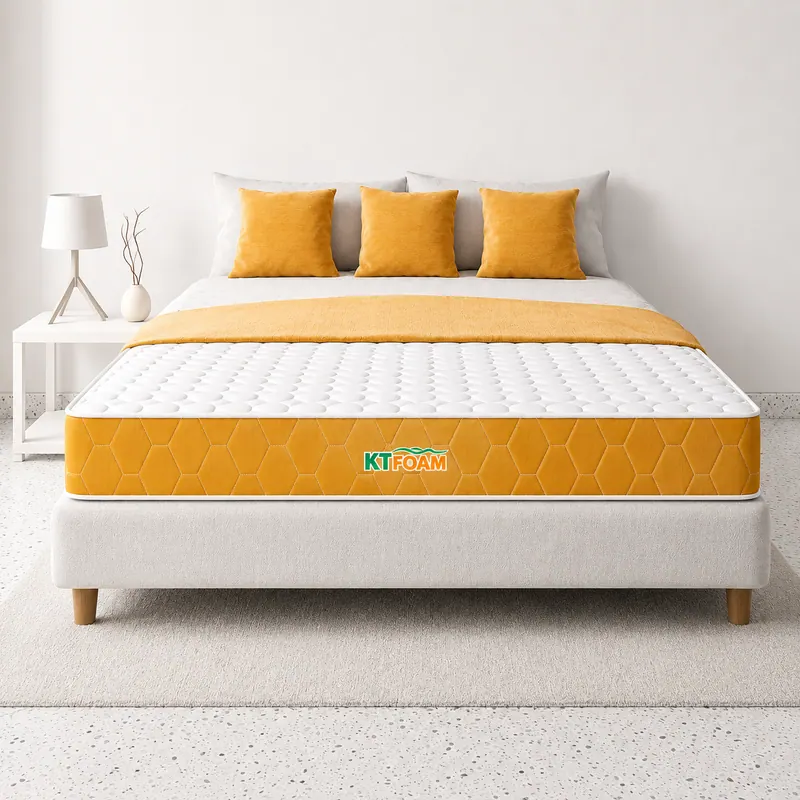 Mattress with a yellow and white cover on a double bed with mustard cushions