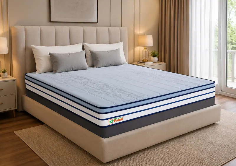 DuroEco mattress with a blue and white striped border on an upholstered bed