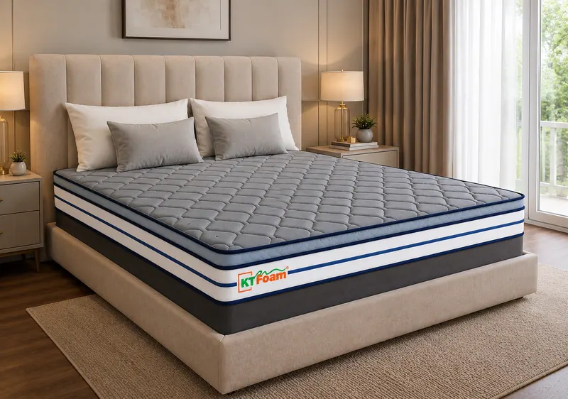 DuroOrtho mattress with a grey quilted top and blue banding on an upholstered bed
