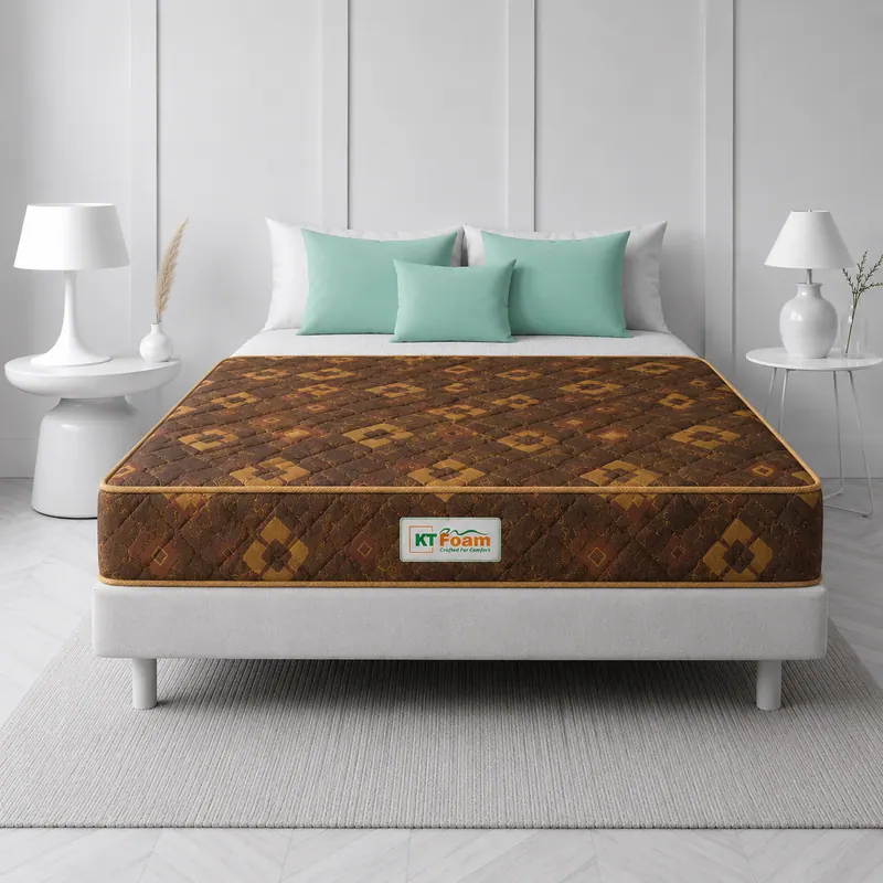 Brown floral-print 6 inch foam mattress on a white bed with mint cushions